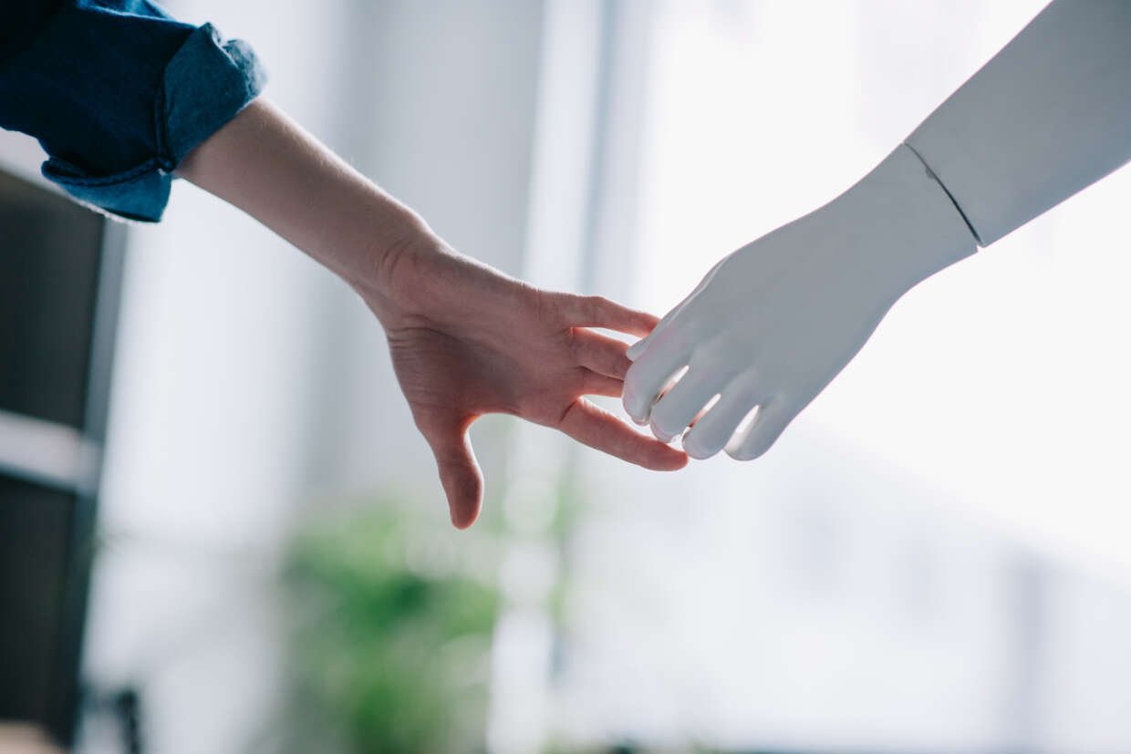 AI technology concept hand holds artificial hand