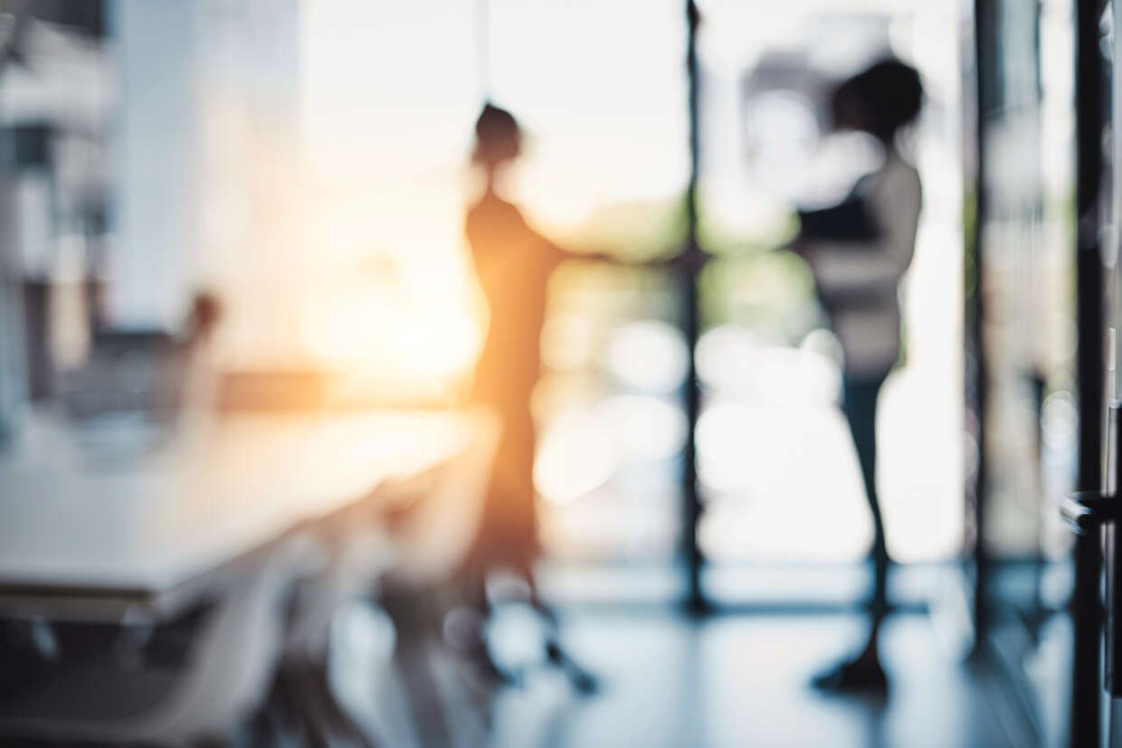 Blurred businesspeople shaking hands