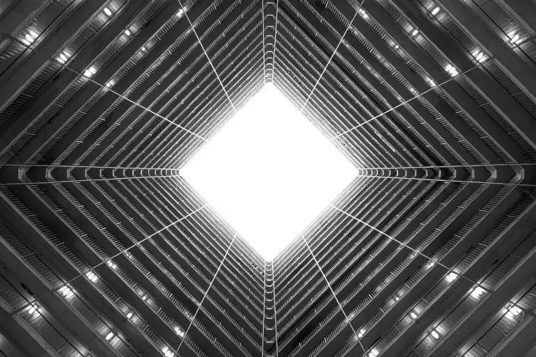 innovation-visual-revops-transformations-concept-abstract-greyscale-low-angle-shot-of-the-light-coming-down-building