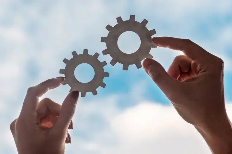 innovation-visual-revops-transformations-concept-holding-gears-up-to-blue-sky
