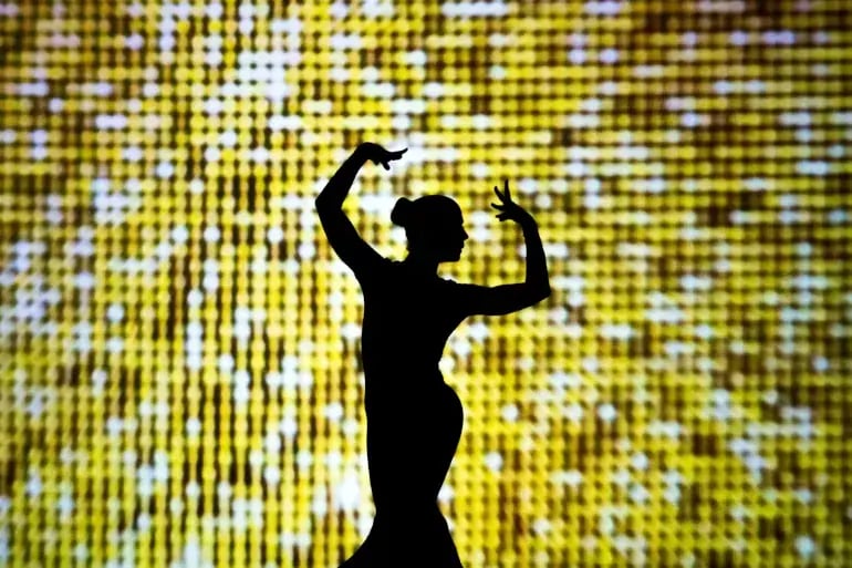 innovation-visual-revops-transformations-concept-silhouette-of-woman-in-front-of-yellow-light-background