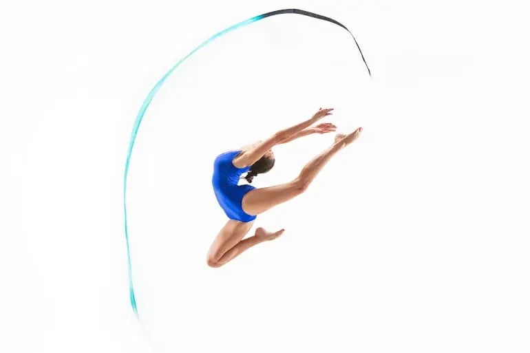 innovation-visual-revops-transformations-concept-woman-gymnast-jumping-with-ribbon