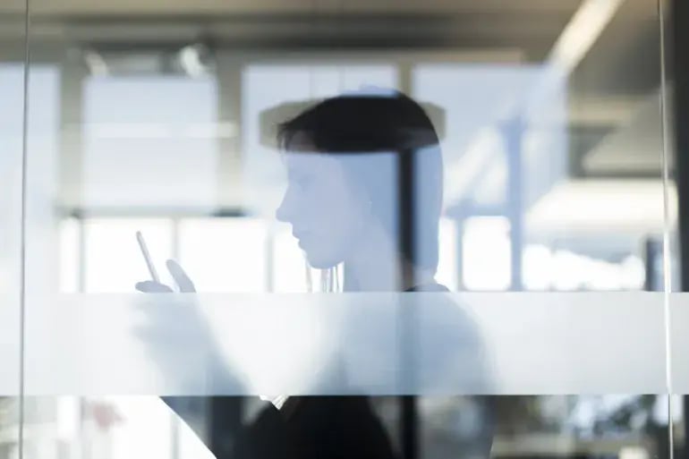 A woman on her mobile phone in the office