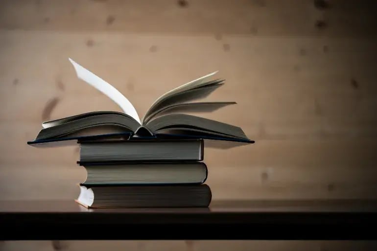 innovation-visual-revops-transformations-stack-of-books-on-wooden-table