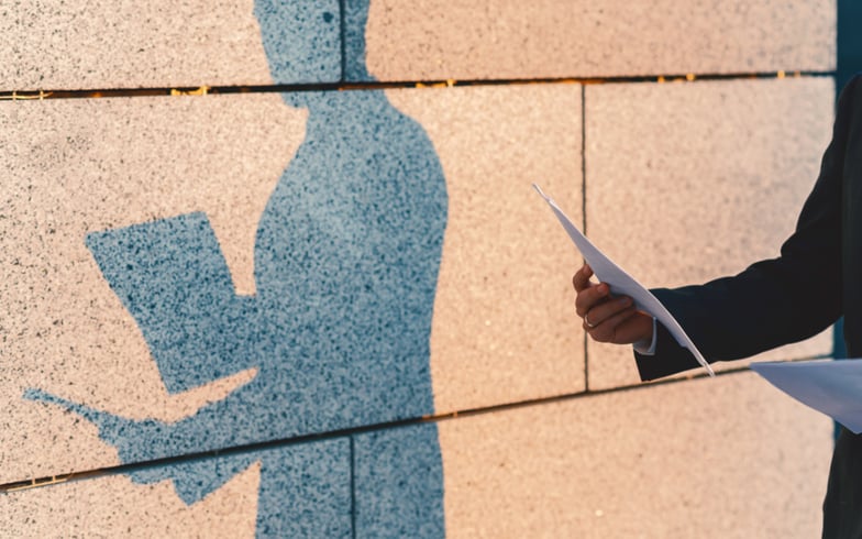 Shadow of a Person holding up documents
