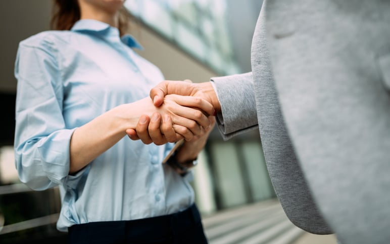 A Graduate shaking hands with their boss on the first week of their job.