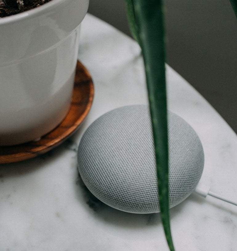Google-Home-Device-Next-To-A-Google-Smart-Speaker