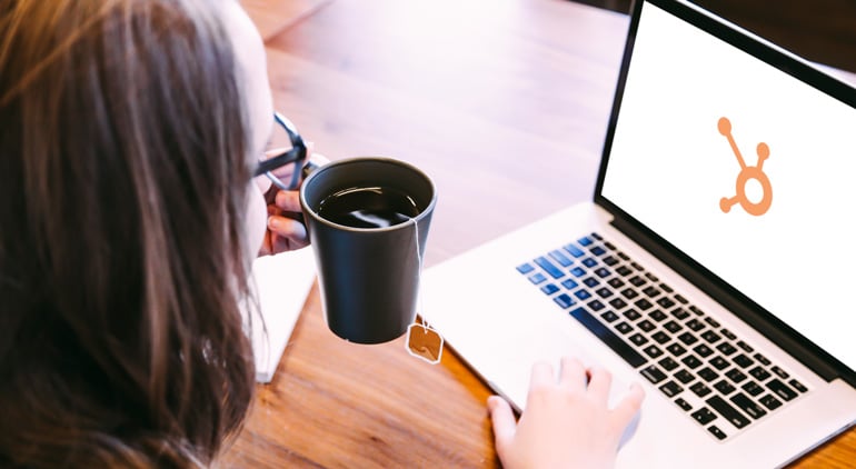 Small-Business-Owner-Discovering-Hubspot-CMS-on-Laptop