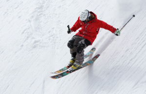 Man skiing down snow covered mountain