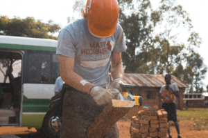 Construction worker cutting wood with a power tool