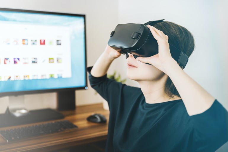 A woman using a virtual reality headset.