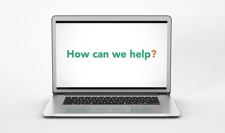 Laptop screen with how can we help text from digital agency