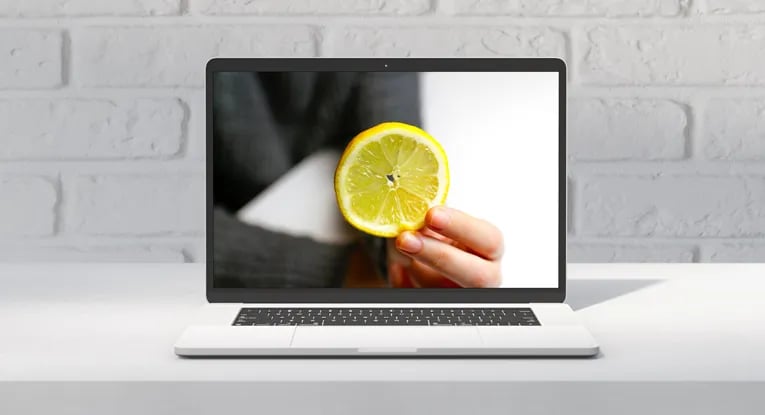hand holding lemon Google freshness score concept on laptop screen