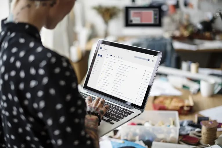 marketing employee using an email CRM system on laptop to drive revenue