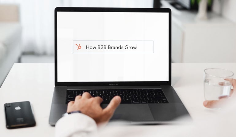 businessman looks at 'How B2B Brands Grow' from Hubspot Inbound 2021 on laptop