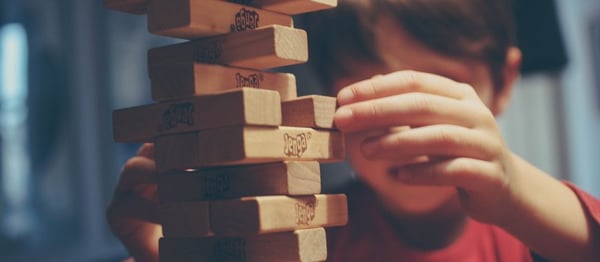 Child moving Jenga blocks