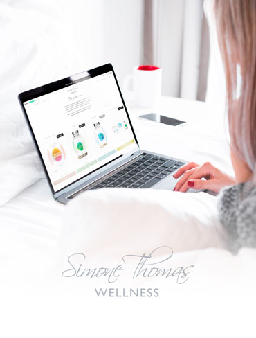 Simone Thomas Wellness logo in front of Innovation Visual-built, SEO optimised website on laptop with woman