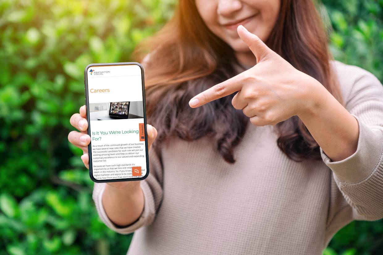 Pointing at careers at Innovation Visual on mobile phone screen 