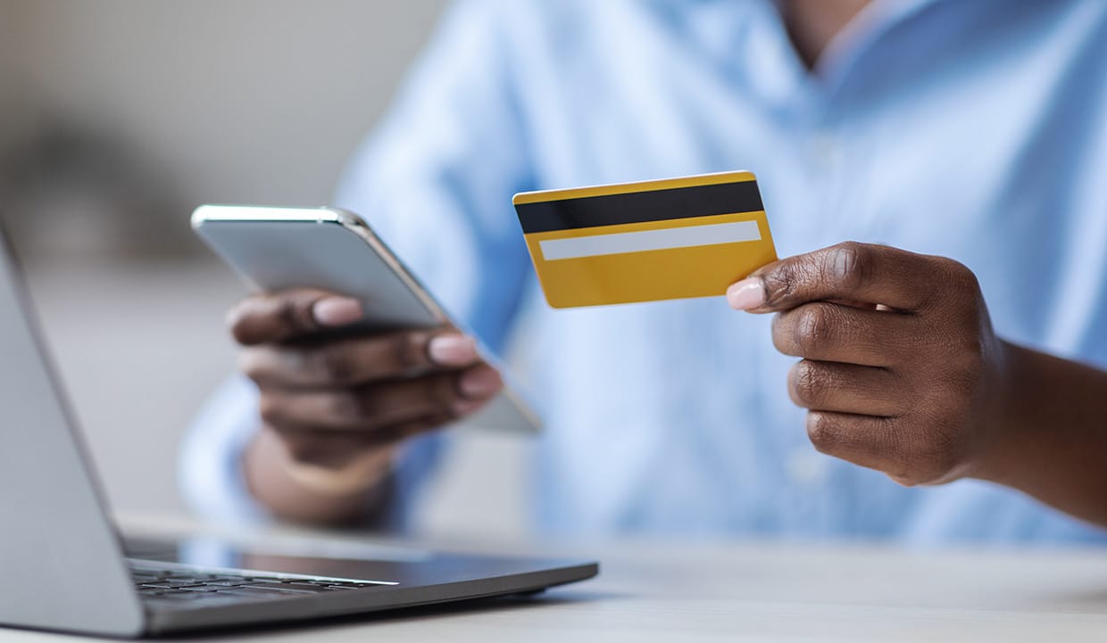 Woman making an online payment with her laptop and mobile