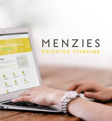 Innovation Visual digital marketing client Menzies logo next to their website on laptop screen