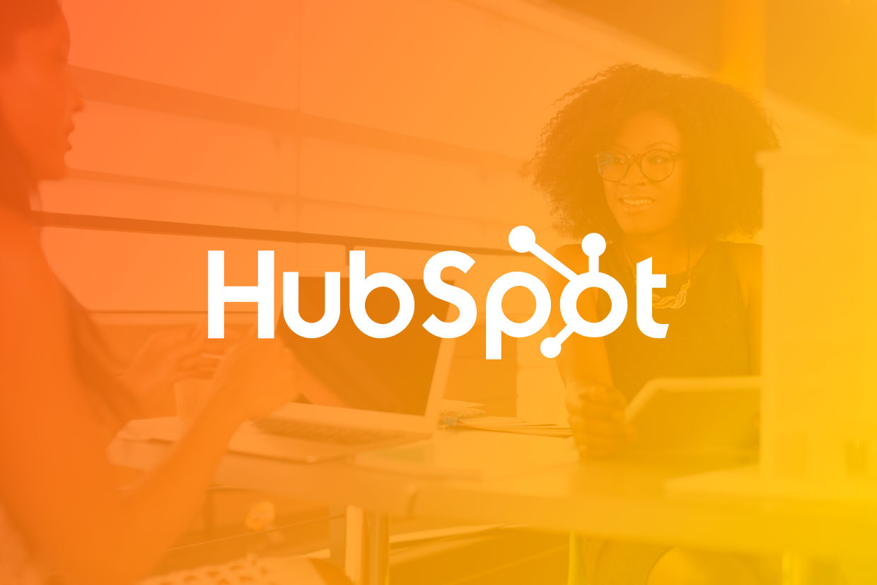 HubSpot monthly update graphic with logo overlayed over women in an office