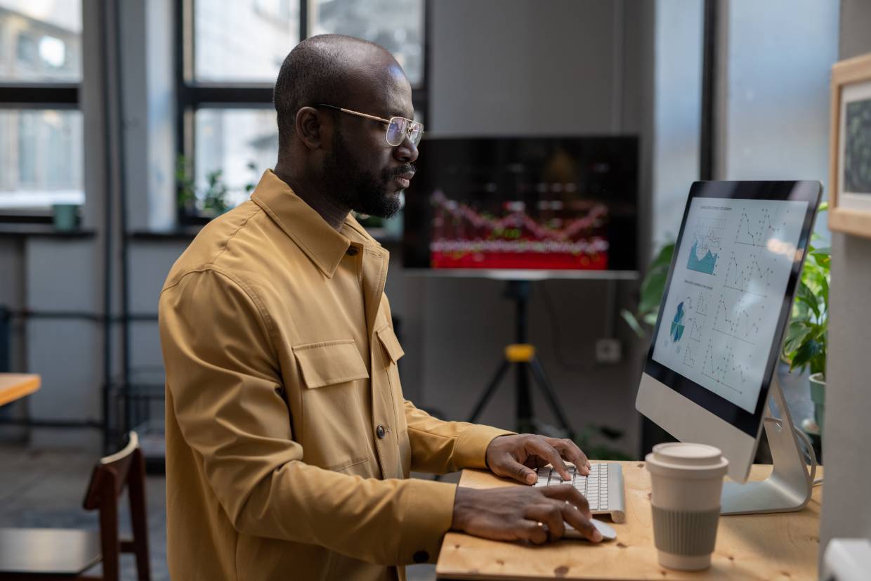 Man looking at advertising in recession data on desktop screen