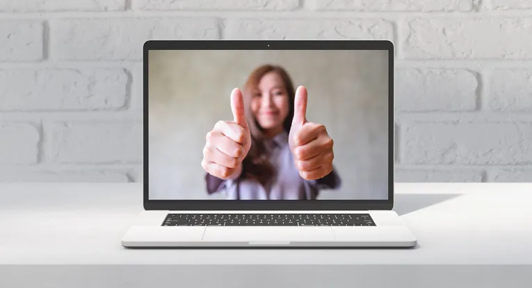 woman with thumbs up helpful content concept on laptop screen